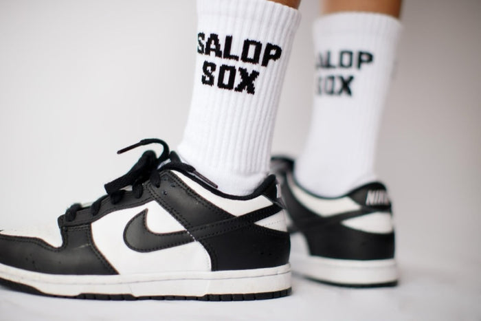 Custom socks for a football fan group, worn with trainers